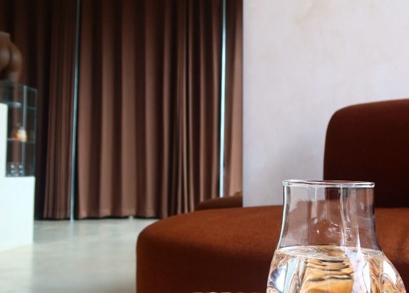 Cozy corner with water pitcher at Booty Bakery, Bali, Bali, ID, showcasing a peaceful ambiance.