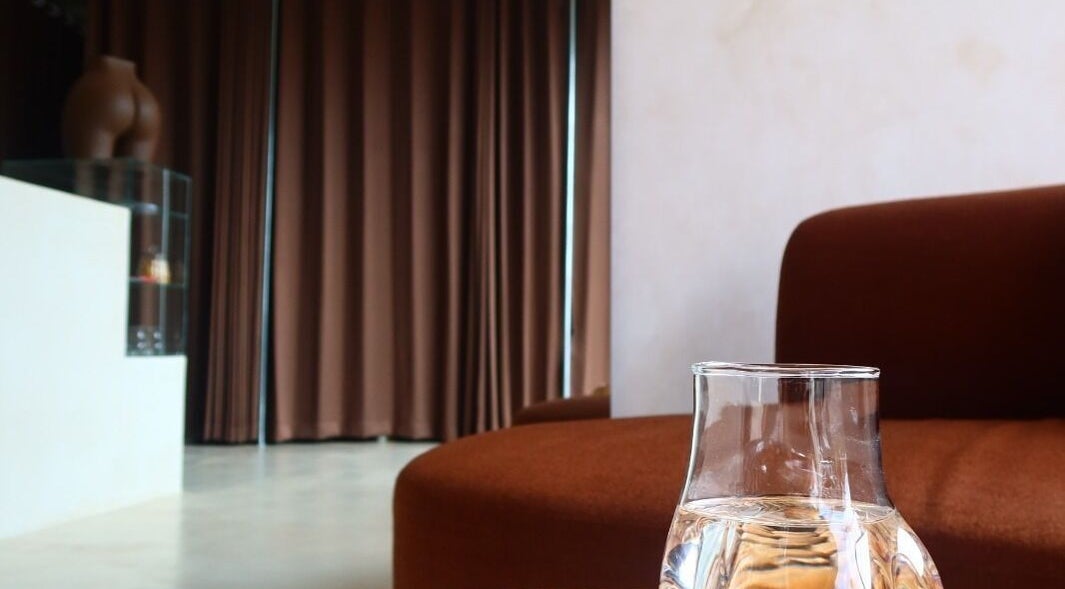 Cozy corner with water pitcher at Booty Bakery, Bali, Bali, ID, showcasing a peaceful ambiance.