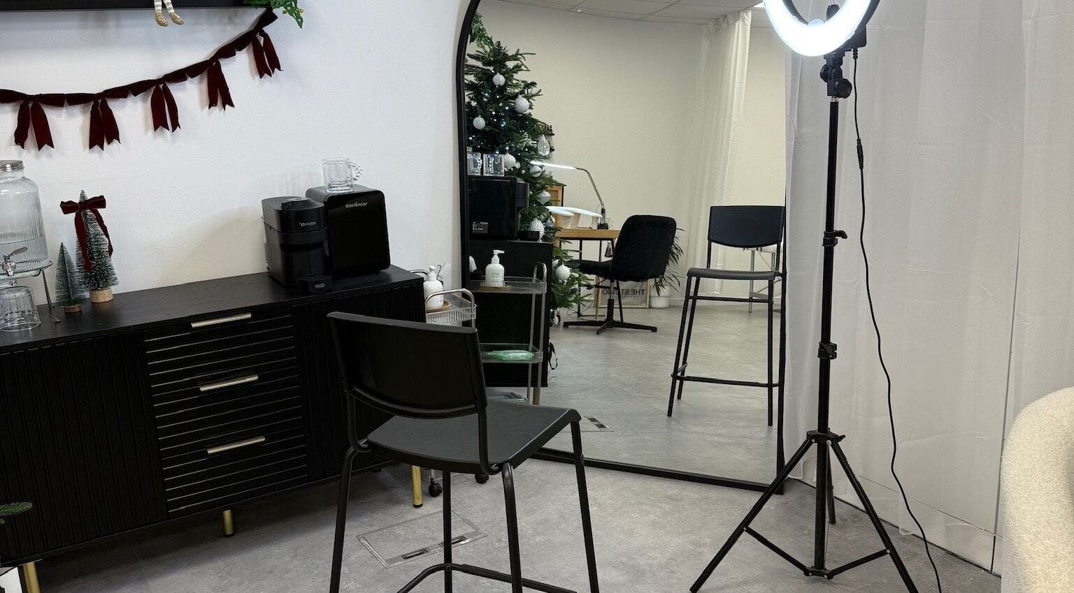 Modern beauty setup at ffi’sFlicks, Cardiff, Wales, GB with salon chair, ring light, and stylish decor.