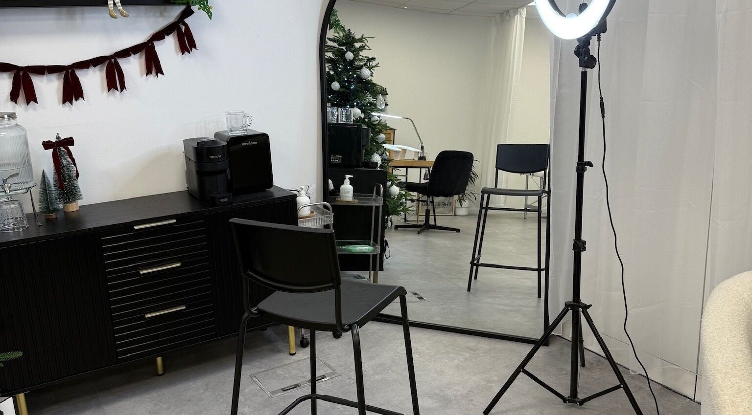 Modern beauty setup at ffi’sFlicks, Cardiff, Wales, GB with salon chair, ring light, and stylish decor.