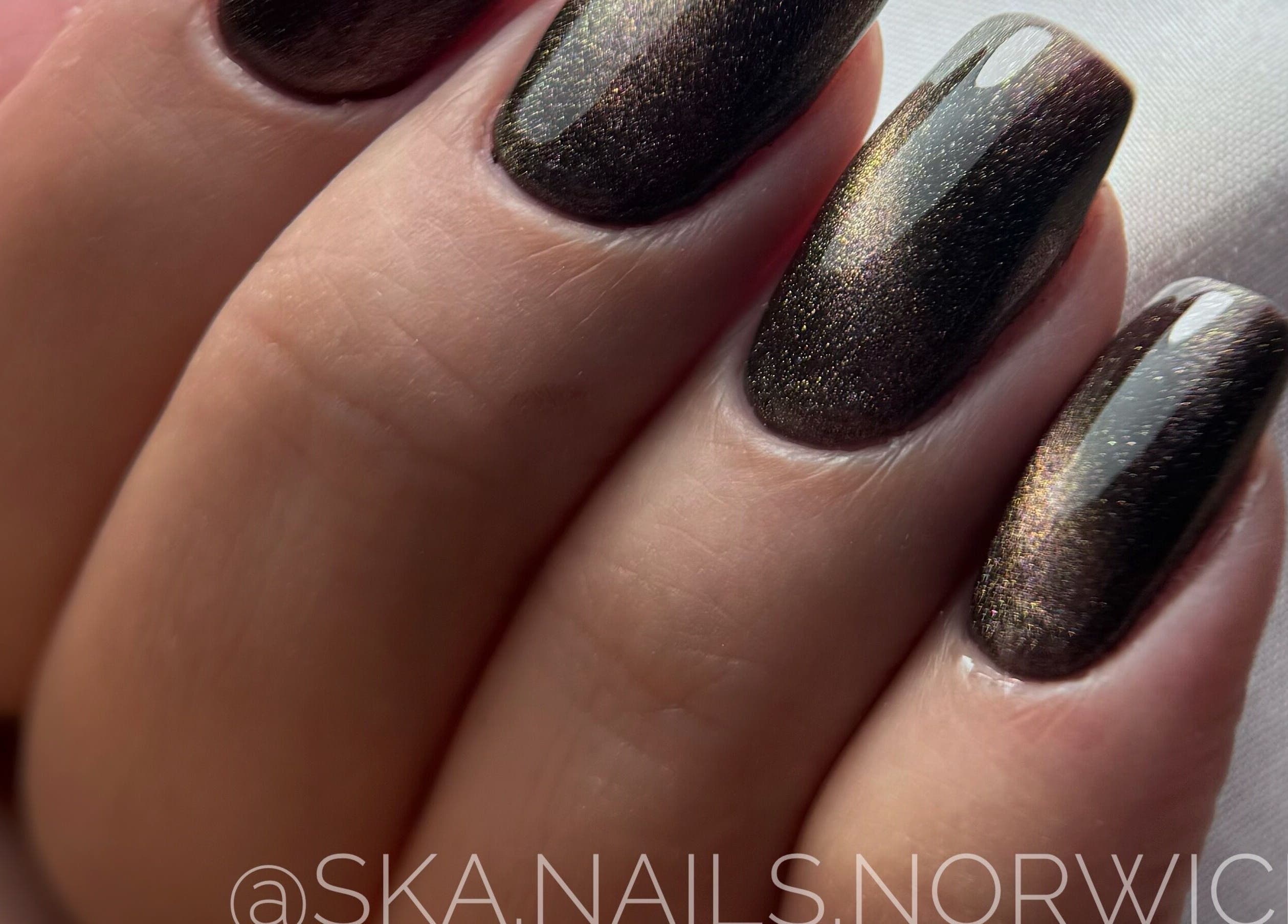 Elegant dark metallic nails from SKA.NAILS, Norwich, England, GB. Perfect for a sophisticated look.