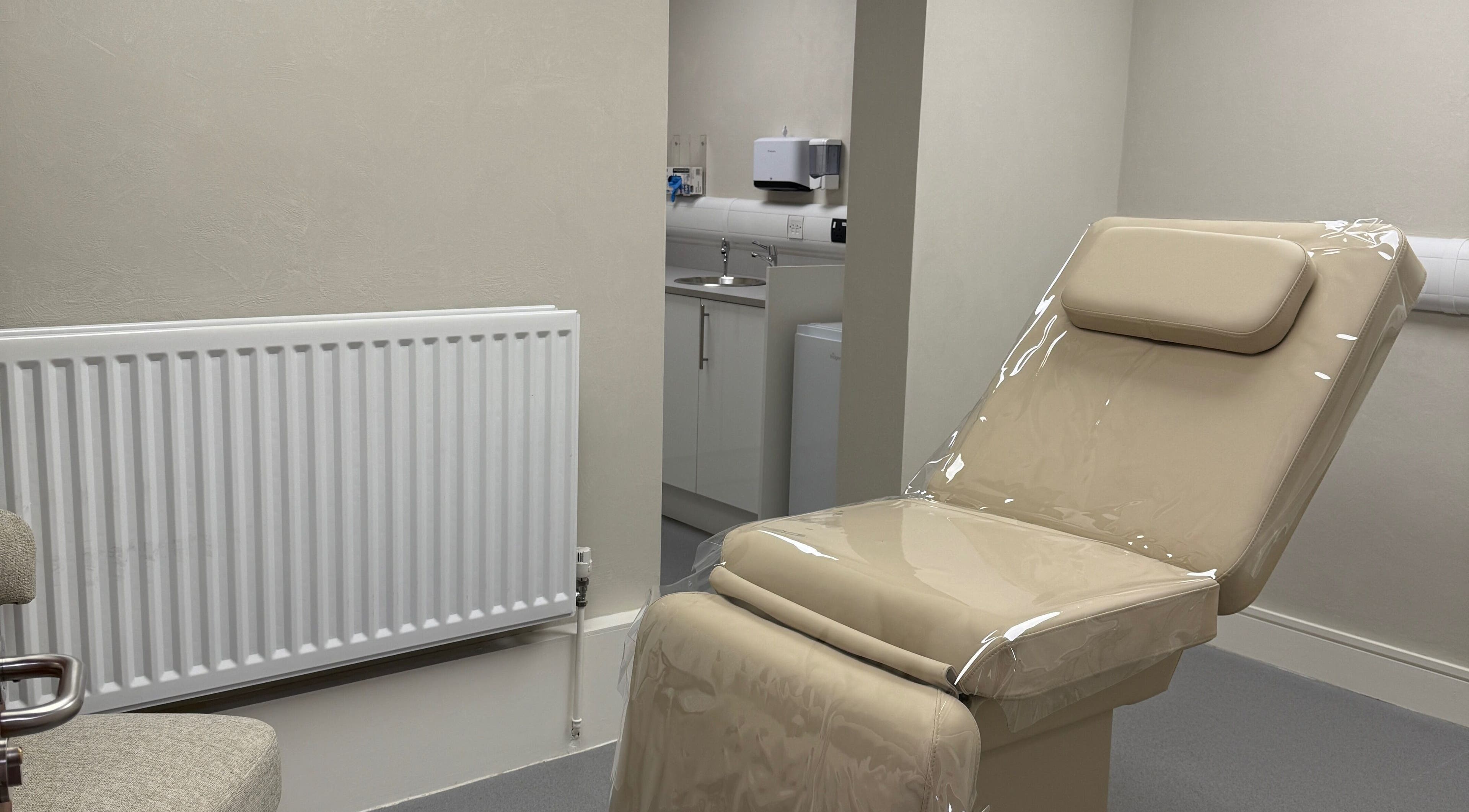 Comfortable treatment room at Laser & Skin Belfast, Belfast, Northern Ireland, GB, featuring a cushioned chair.