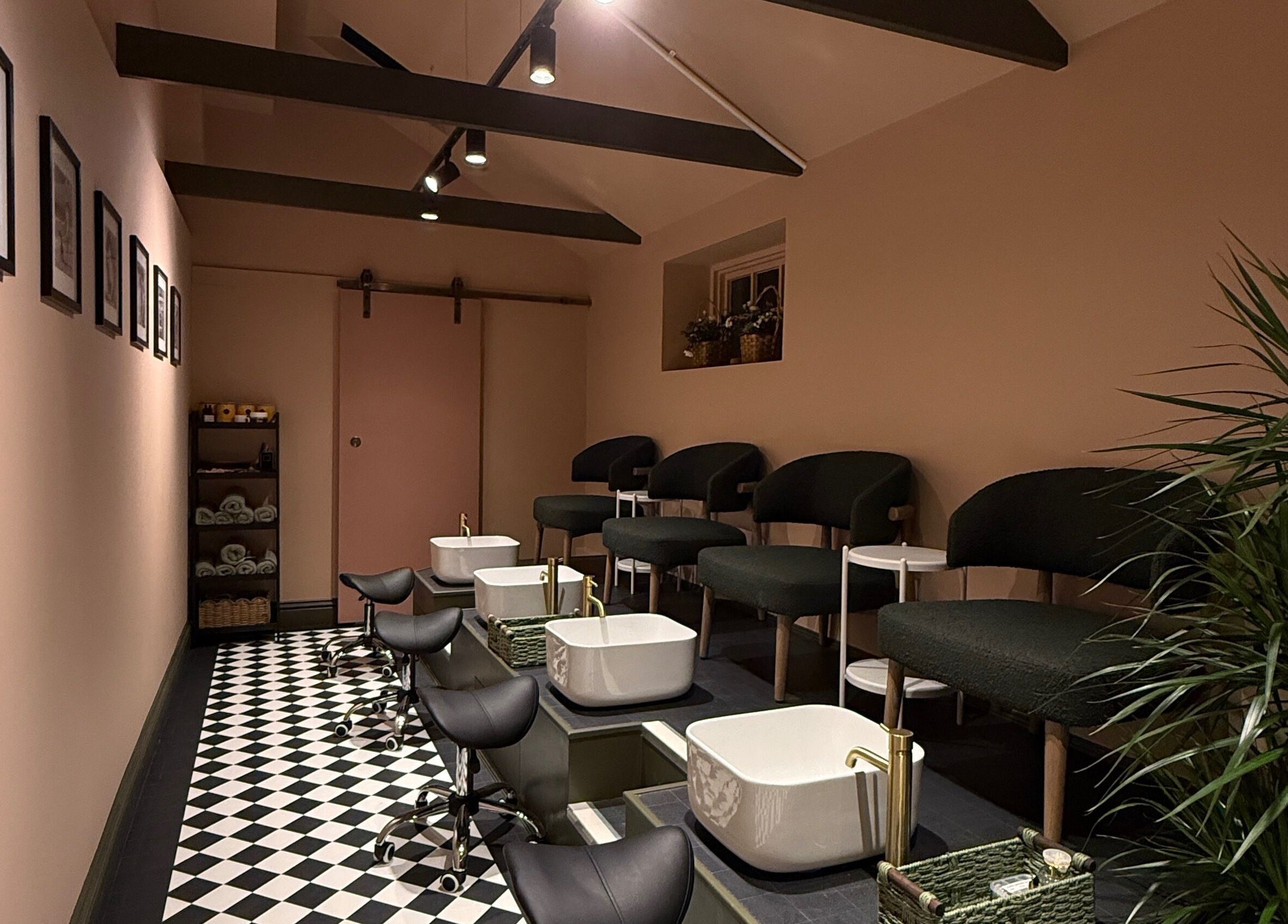 GOLDFINCH NAILS STUDIO in Haslemere, England, features chic pedicure stations with stylish decor and cozy seating.