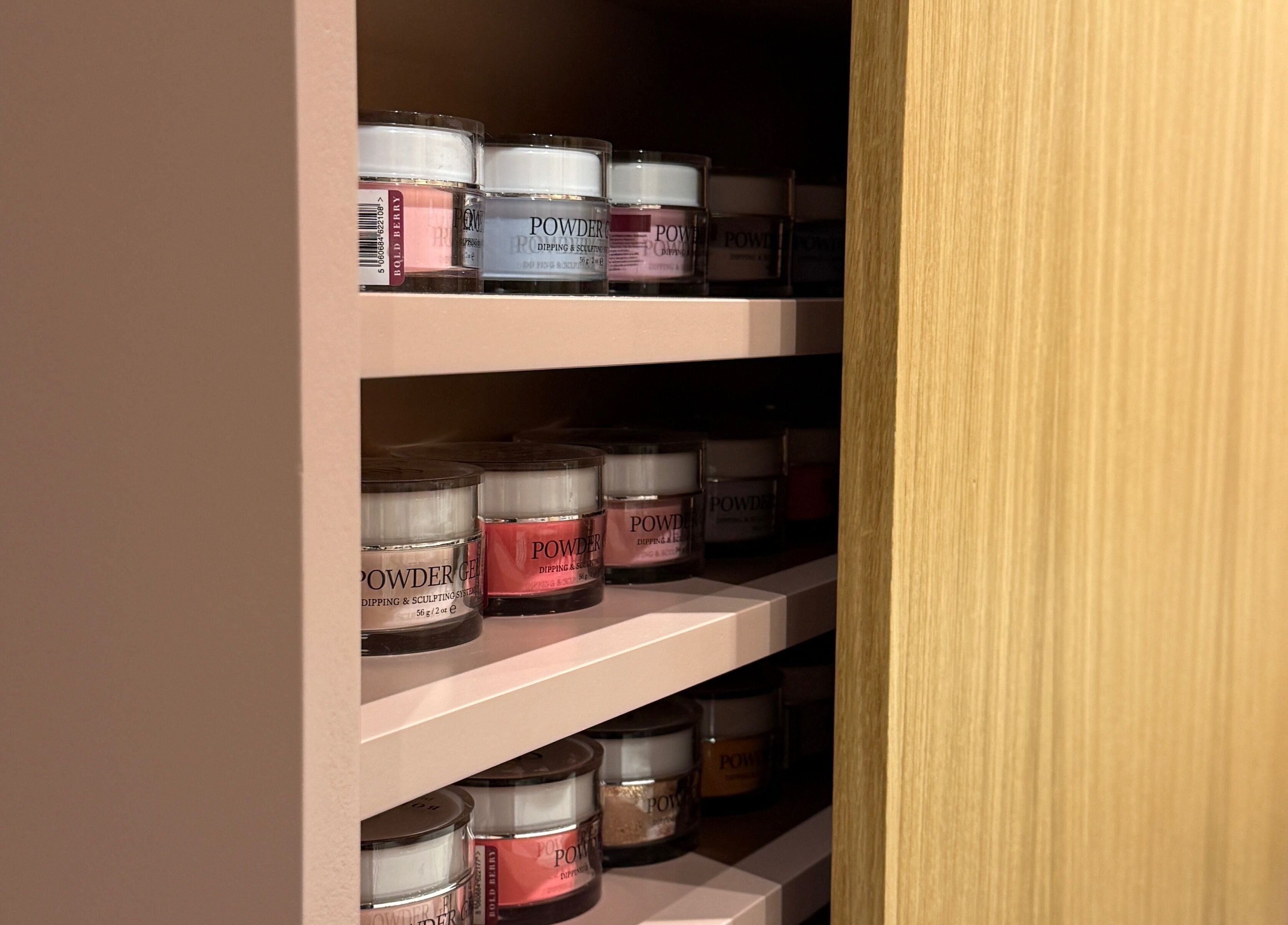A vibrant selection of nail powders neatly displayed at GOLDFINCH NAILS STUDIO in Haslemere, England, GB.