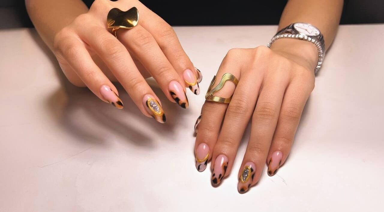 Elegant nail art with golden accents at Nstudio.to, Toronto, Ontario, CA. Trendy and stylish manicure.