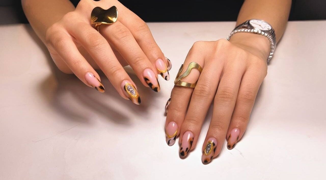 Elegant nail art with golden accents at Nstudio.to, Toronto, Ontario, CA. Trendy and stylish manicure.