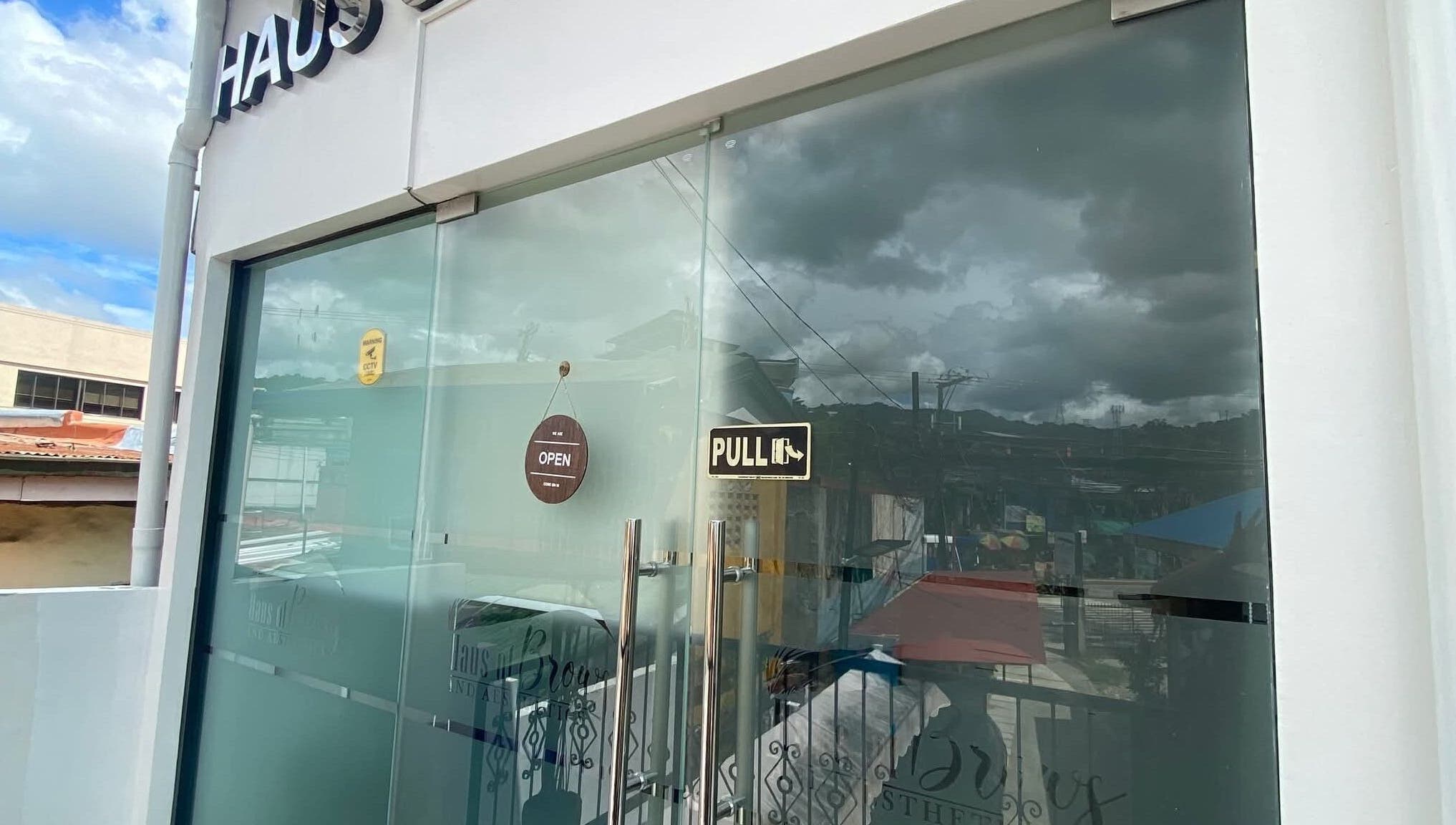 Front glass door of Haus of Brows & Aesthetics Cebu in Cebu City, Central Visayas, PH with open sign.