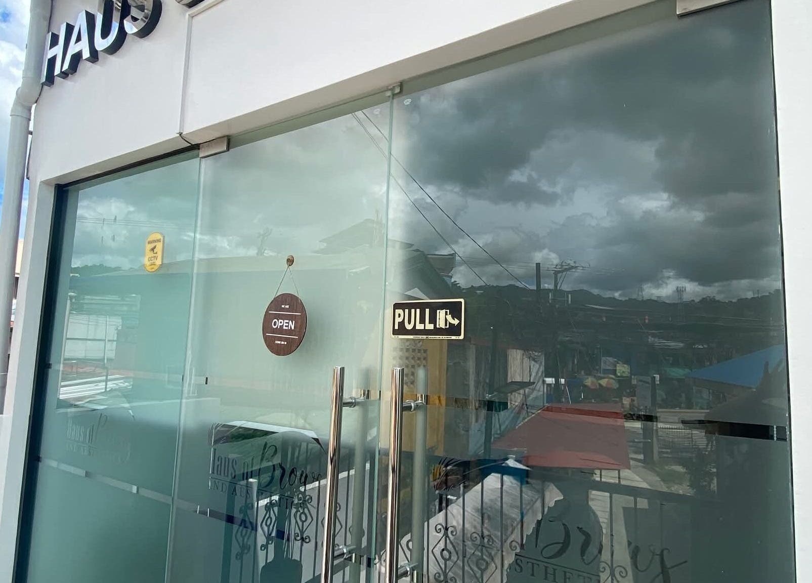 Front glass door of Haus of Brows & Aesthetics Cebu in Cebu City, Central Visayas, PH with open sign.
