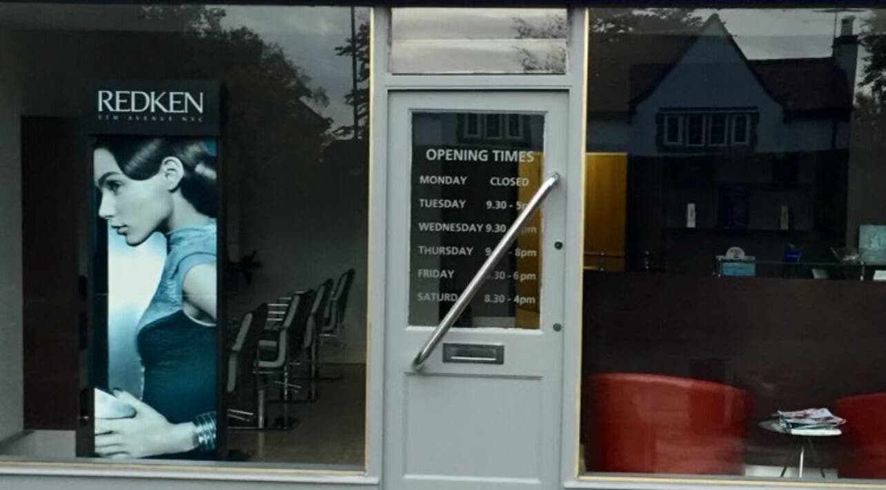 Front view of RG Hairdressing in Bramhope, England with modern design and operating hours displayed.