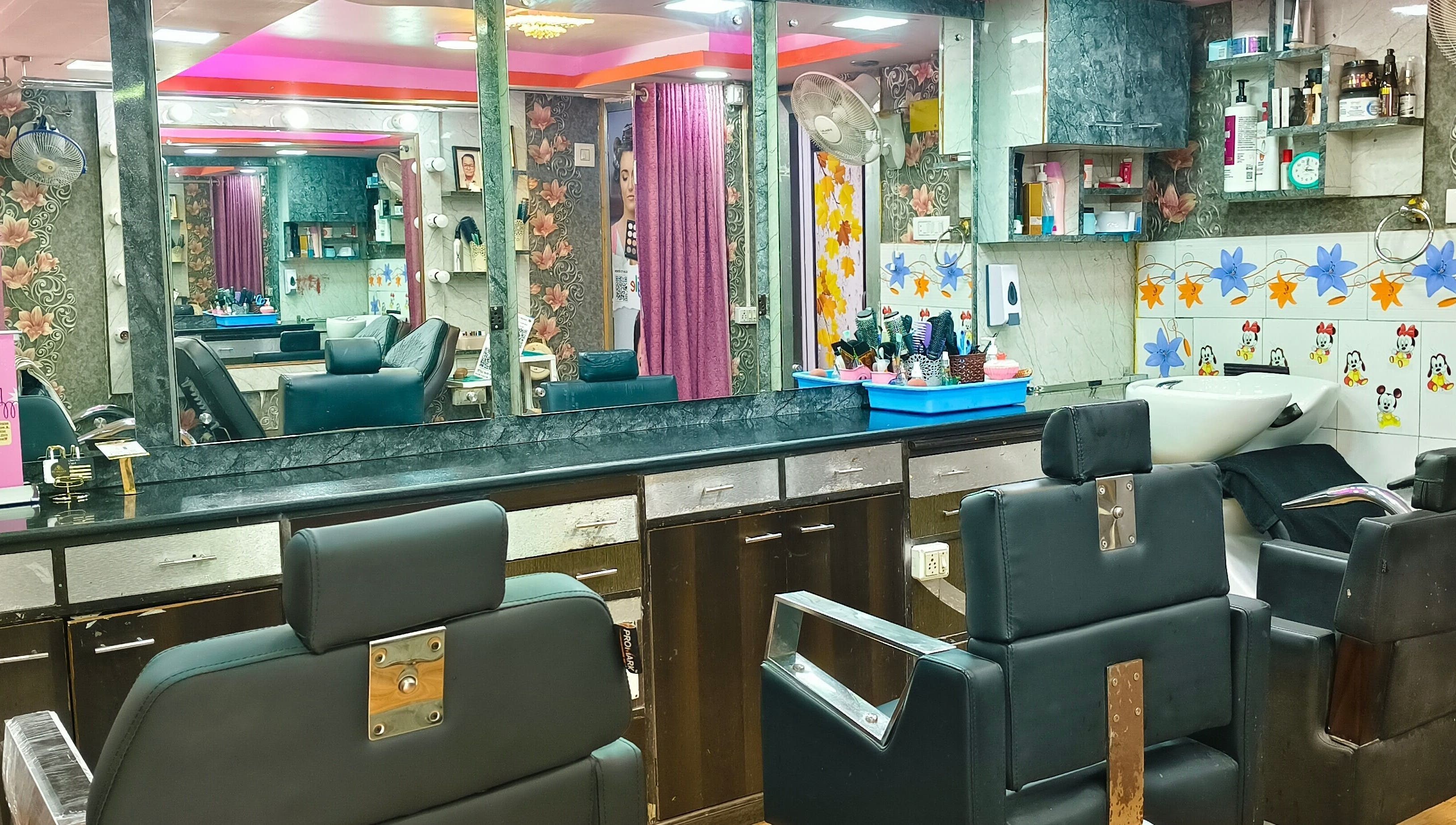 Interior of Ruposhi Beauty Parlour in Kolkata, West Bengal, IN featuring modern salon chairs and floral decor.