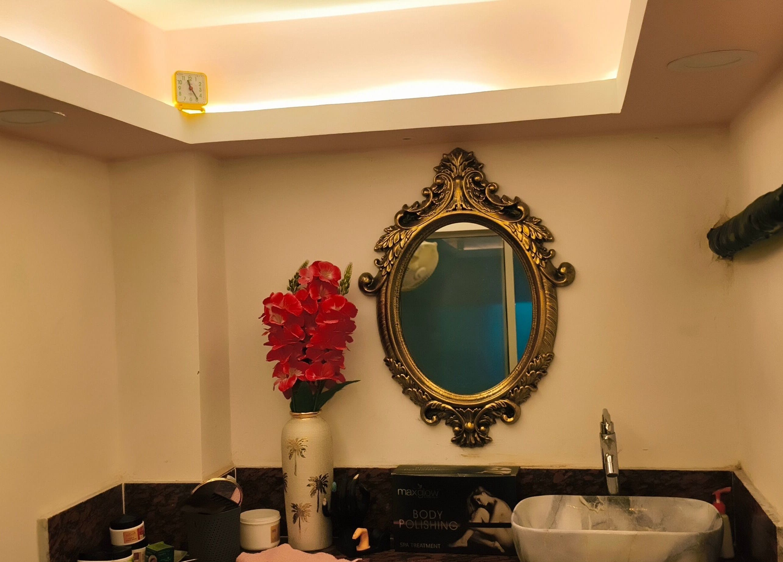 Ornate mirror with vase and products at Ruposhi Beauty Parlour, Kolkata, West Bengal, IN.