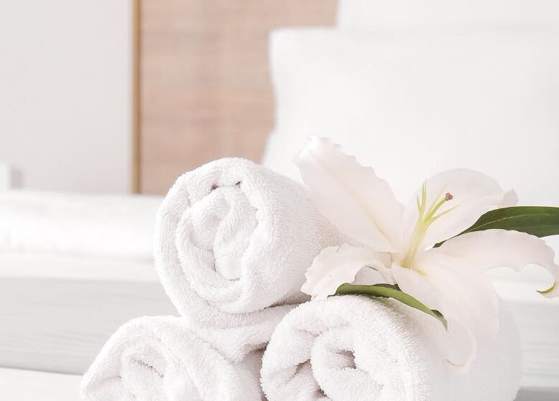 Elegant rolled towels with a flower at Warch Airbnb Care, Coolangatta, Queensland, AU.
