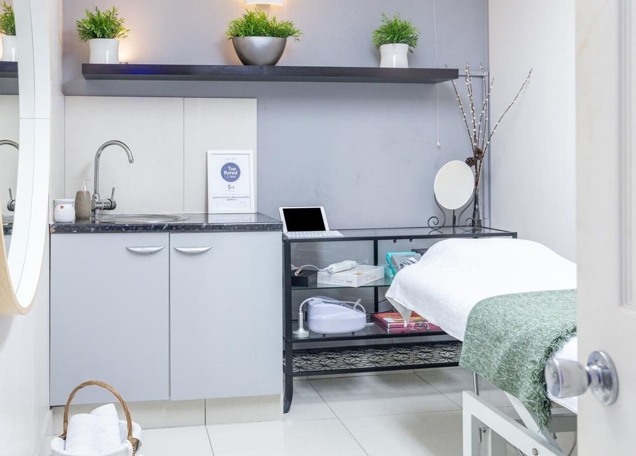 Cozy treatment room at Aesthetics by Elena, London, England, GB featuring a spa bed and tranquil decor.