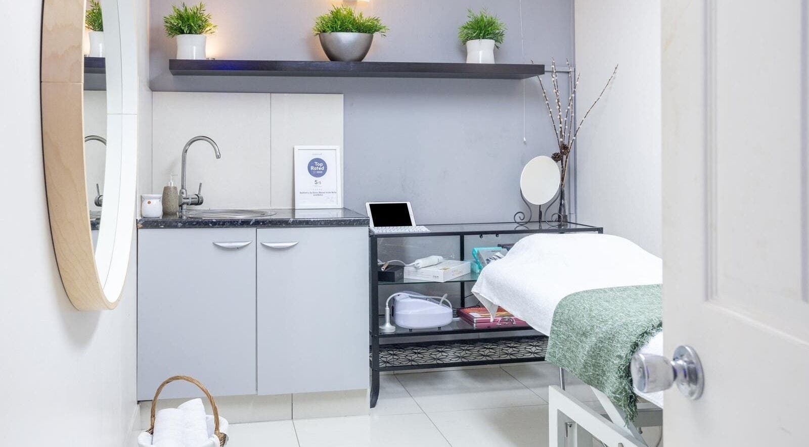 Cozy treatment room at Aesthetics by Elena, London, England, GB featuring a spa bed and tranquil decor.