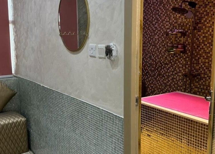 Elegant interior of Bronzette Beauty Salon L.L.C in Dubai, AE, featuring a stylish lounge and luxurious massage area.