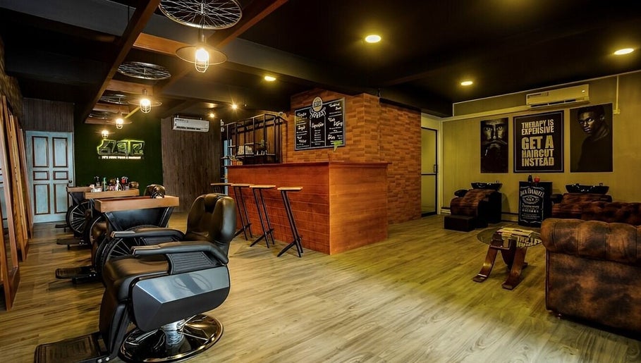 Interior view of Raula Barbershop Baseline Road, Colombo, Western Province, LK, showcasing sleek chairs and warm decor.