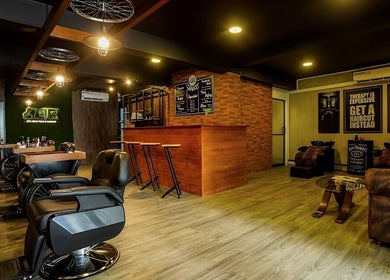Interior view of Raula Barbershop Baseline Road, Colombo, Western Province, LK, showcasing sleek chairs and warm decor.
