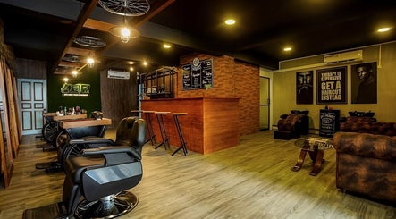 Interior view of Raula Barbershop Baseline Road, Colombo, Western Province, LK, showcasing sleek chairs and warm decor.