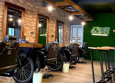 Interior of Raula Barbershop Baseline Road, Colombo, featuring sleek black chairs and rustic decor.