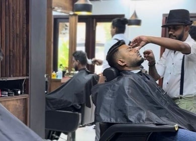 Stylist shaping a client's beard at Raula Barbershop Park Road, Colombo, Western Province, LK.