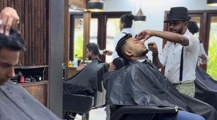 Stylist shaping a client's beard at Raula Barbershop Park Road, Colombo, Western Province, LK.