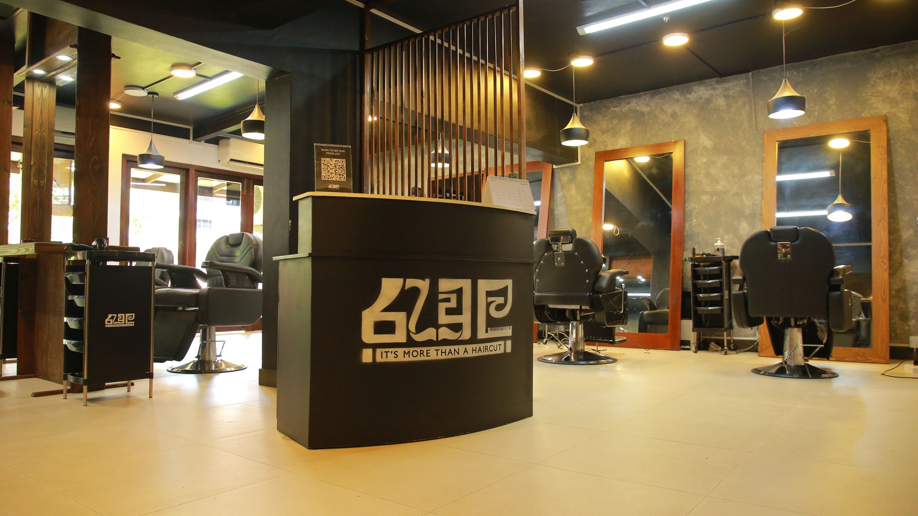 Modern interior of Raula Barbershop Park Road in Colombo, Western Province, LK with sleek chairs and mirrors.