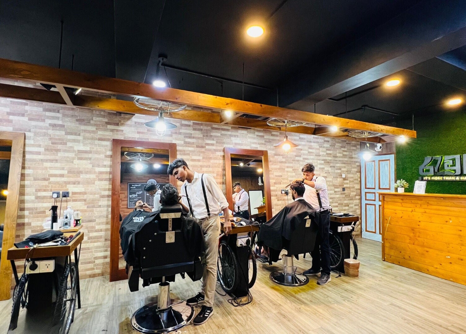 Stylish interior of Raula Barbershop Baseline Road in Colombo, Western Province, LK with barbers at work.
