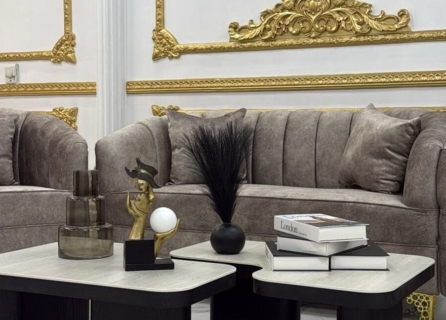 Luxurious lounge area at Stellar Beauty in Doha, Doha Municipality, QA with plush sofas and golden accents.