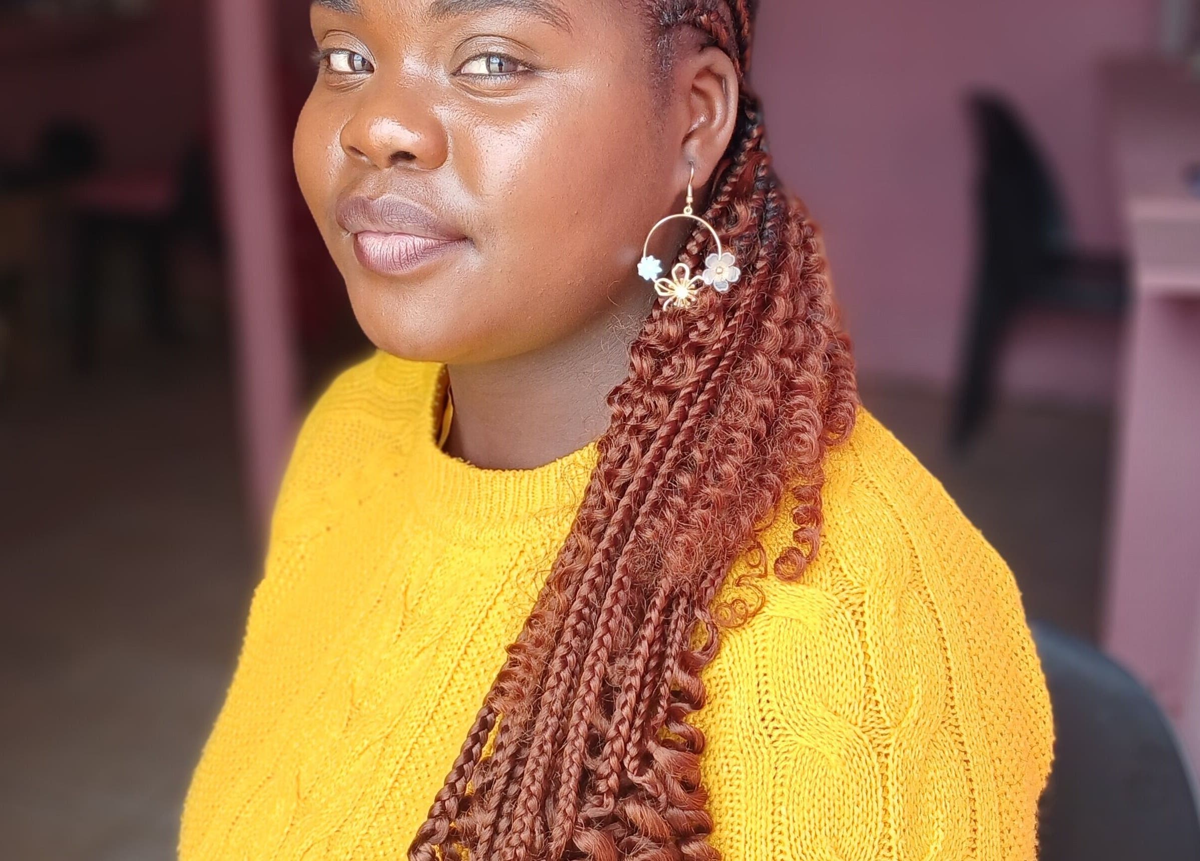 A smiling customer with styled braids at Majona Hairsalon, Swakopmund, Erongo Region, NA.