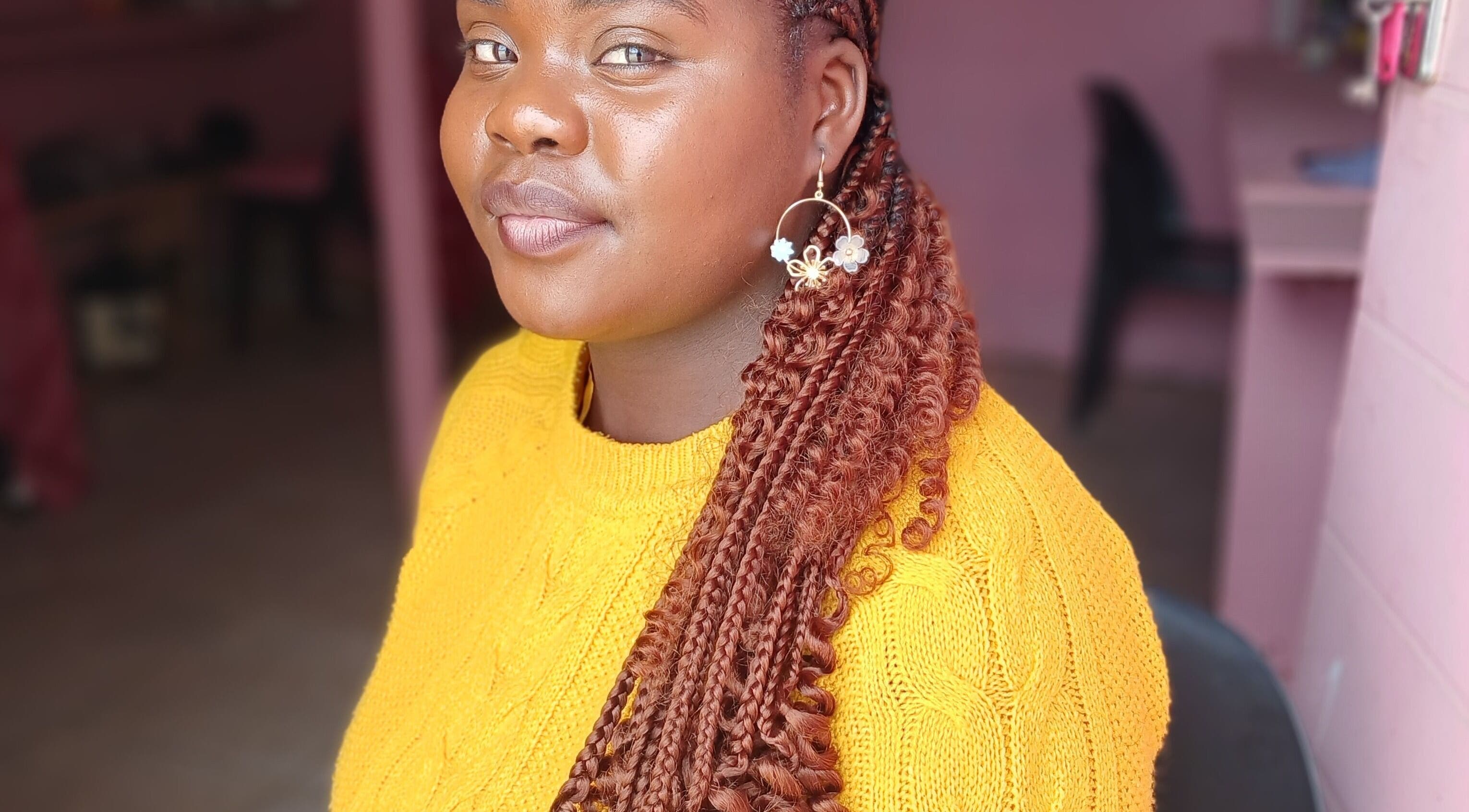 A smiling customer with styled braids at Majona Hairsalon, Swakopmund, Erongo Region, NA.