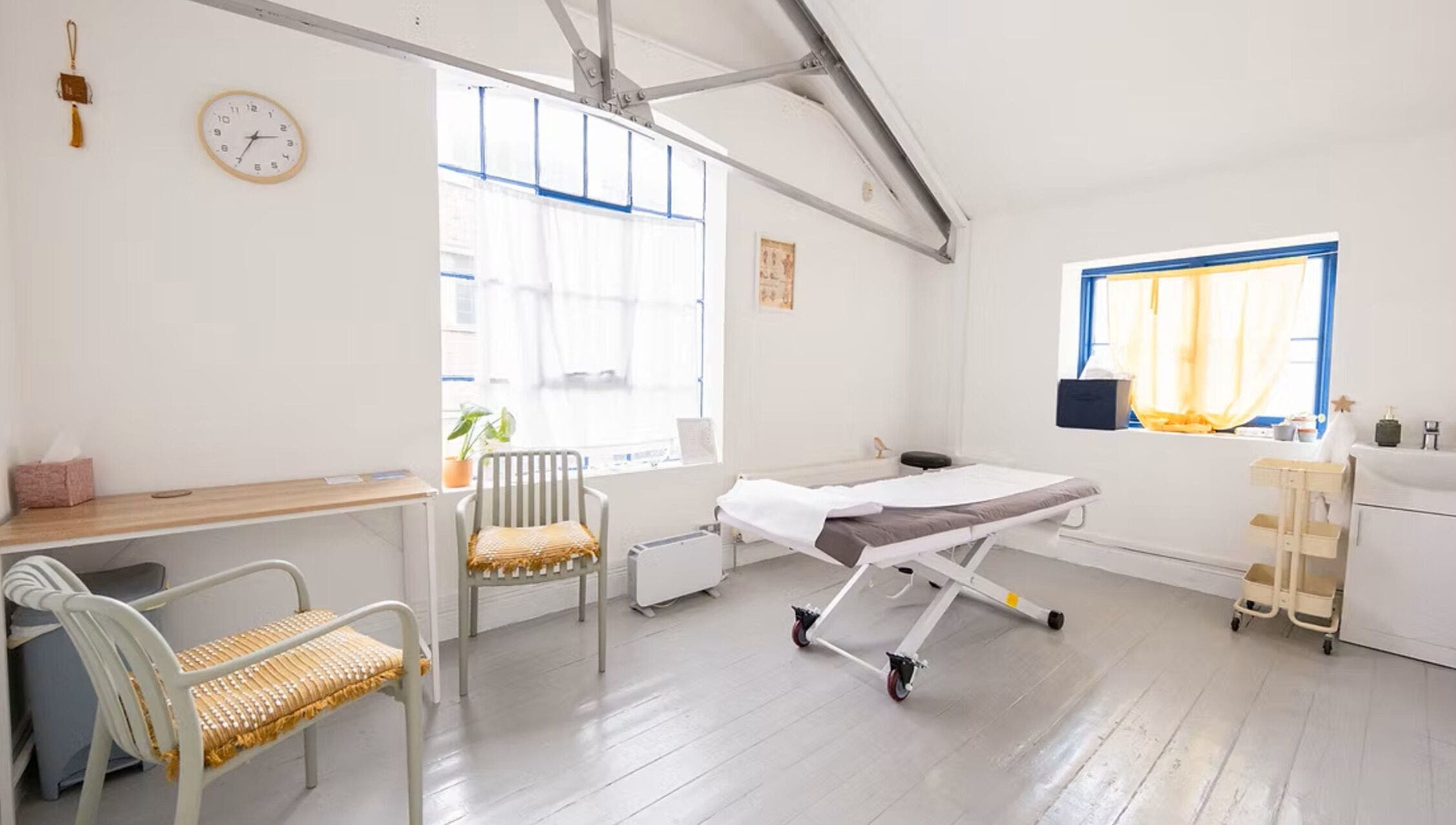 Relaxing therapy room at Venus Holistic Therapies at Prana Voice, London, England, GB, with massage table.