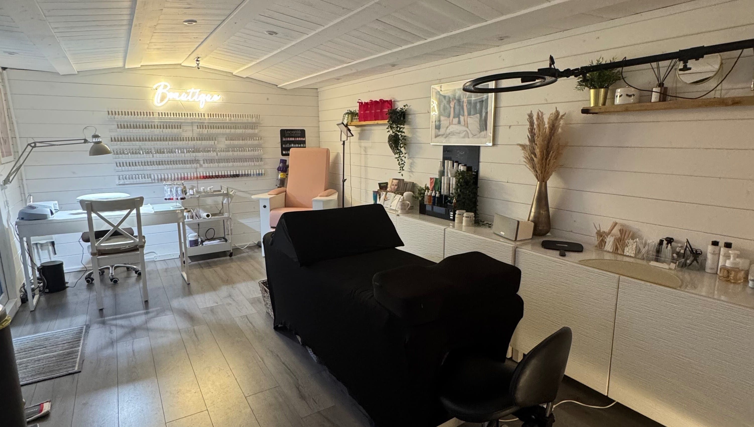 Interior of Beautique Beauty Studio, Warninglid, England, GB; modern, elegant decor with cozy chairs and treatment tables.