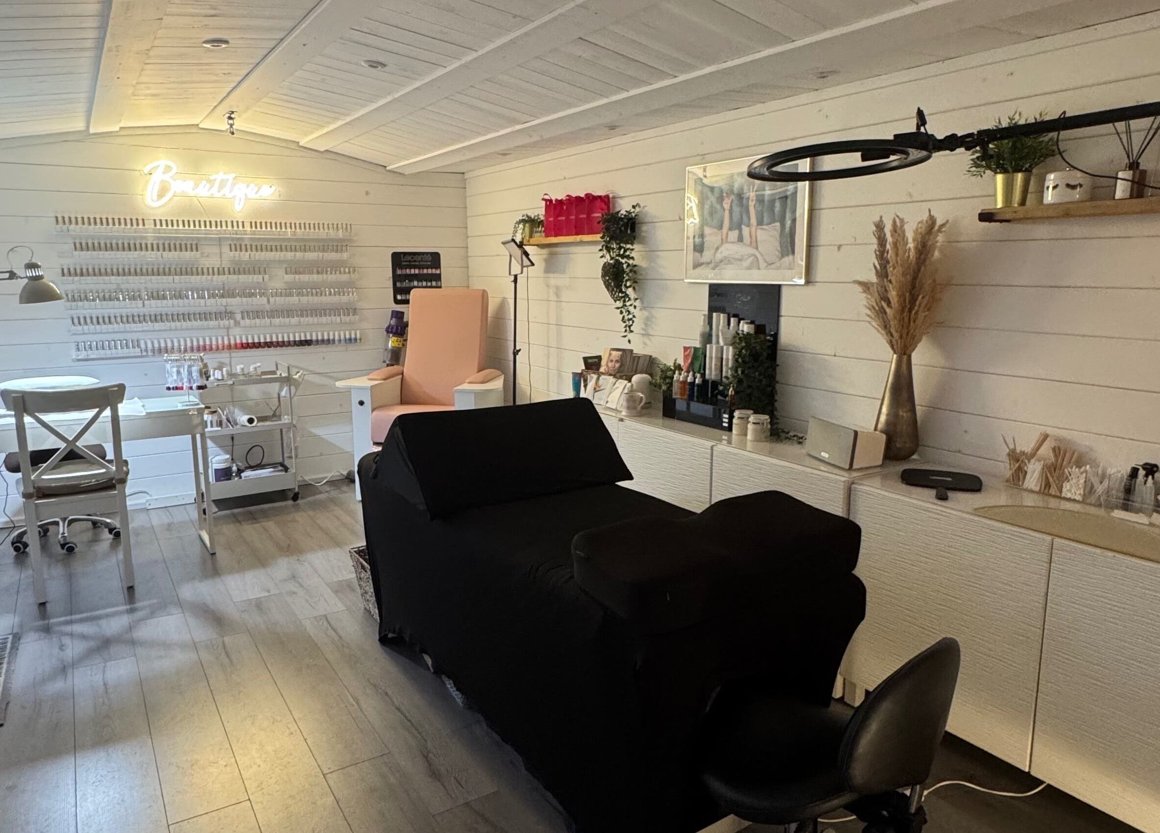 Interior of Beautique Beauty Studio, Warninglid, England, GB; modern, elegant decor with cozy chairs and treatment tables.