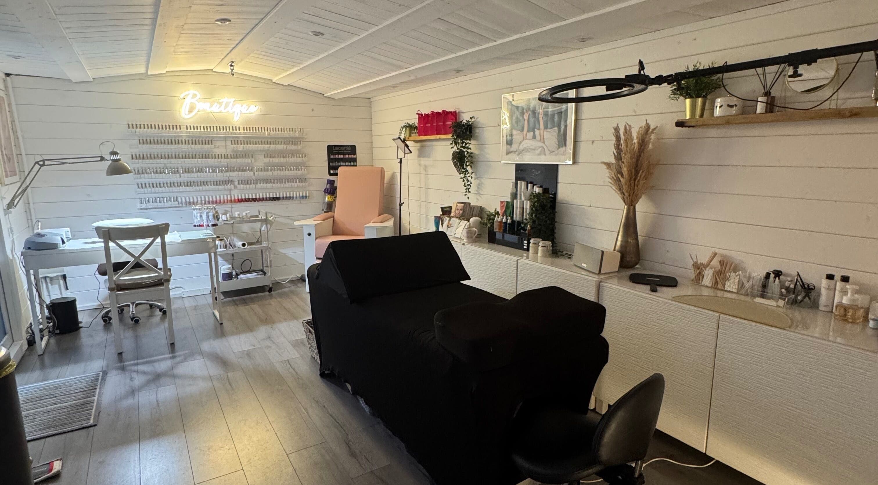 Interior of Beautique Beauty Studio, Warninglid, England, GB; modern, elegant decor with cozy chairs and treatment tables.
