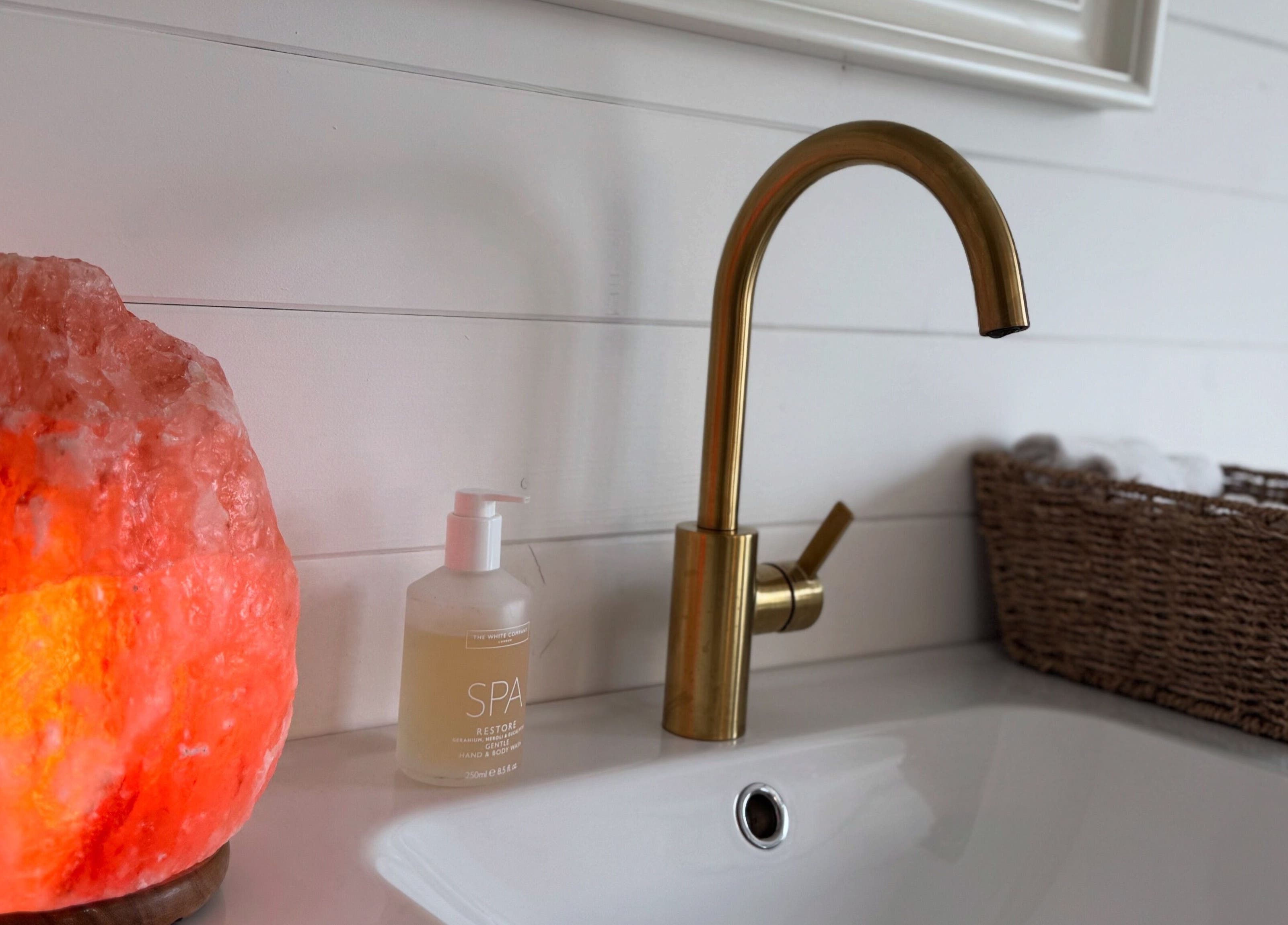 Golden faucet and Himalayan salt lamp at Beautique Beauty Studio, Warninglid, England, GB.