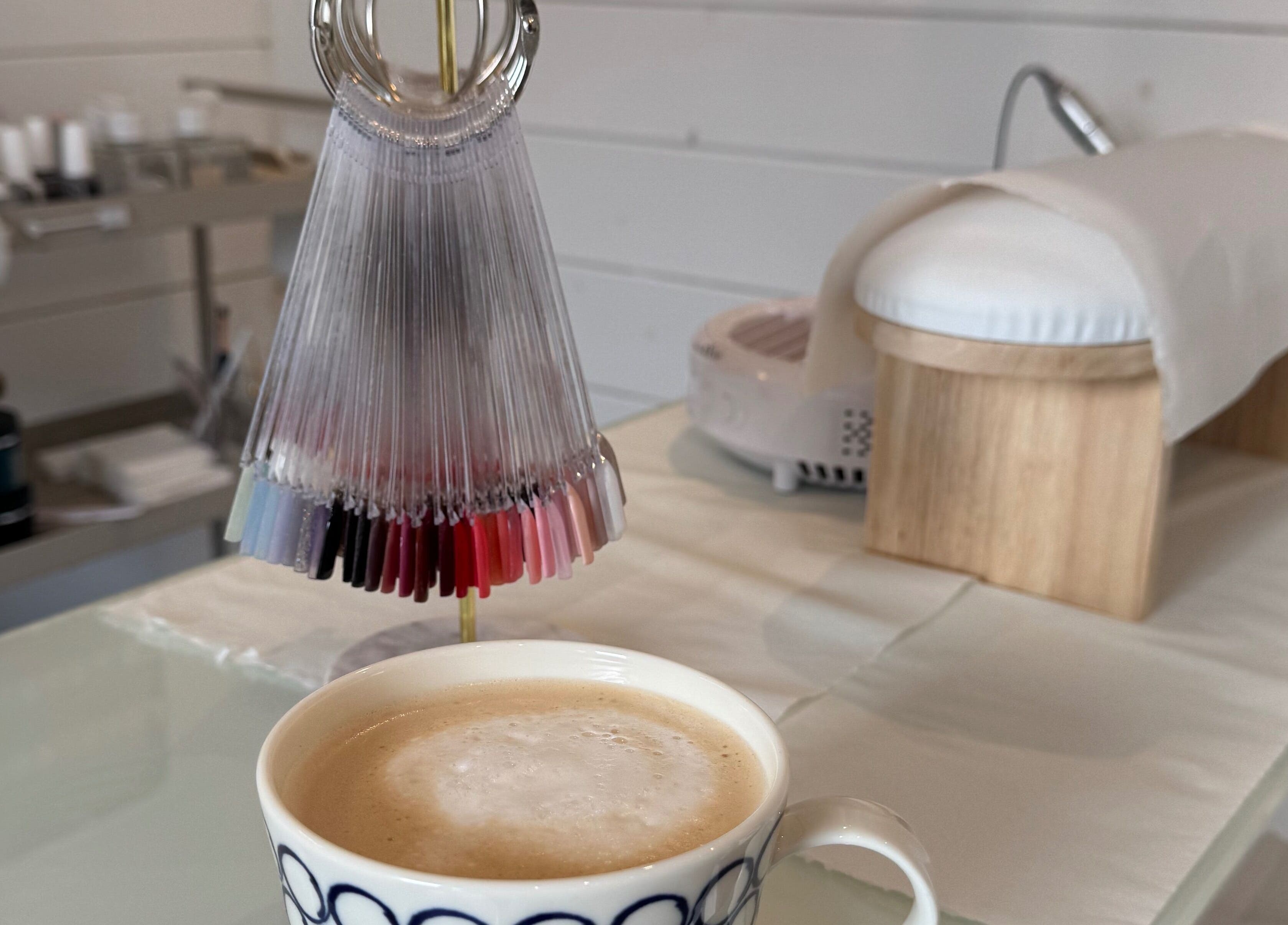 A relaxing nail station at Beautique Beauty Studio, Warninglid, England, GB with coffee and polish samples.