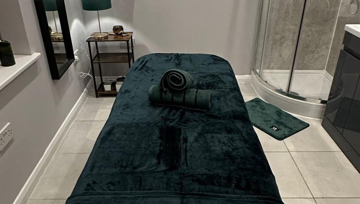 Luxurious massage room at Elite Emerald Spa, London, England, GB, featuring a plush treatment table.