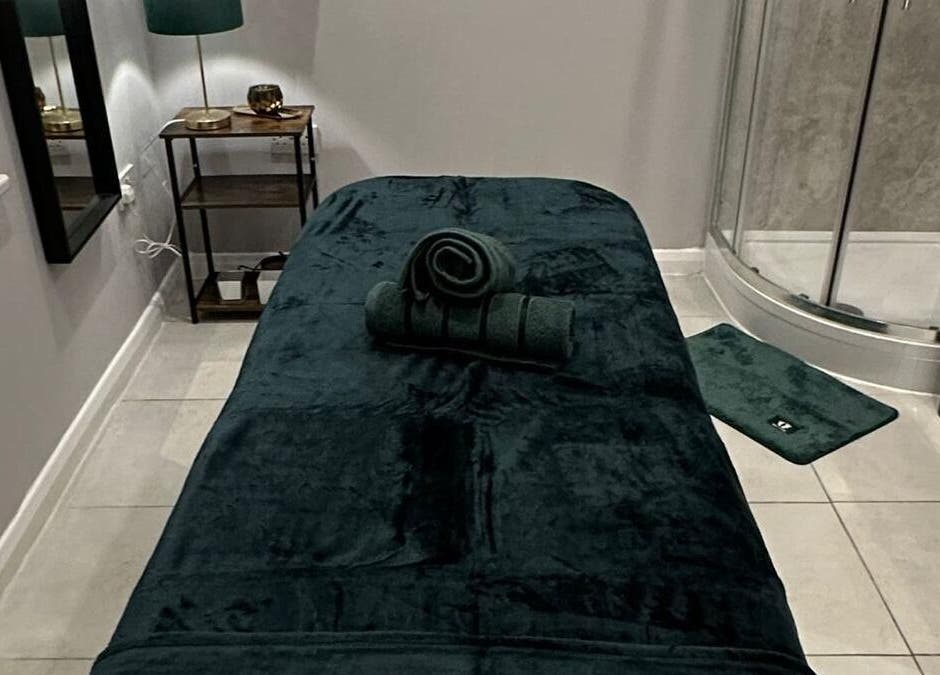 Luxurious massage room at Elite Emerald Spa, London, England, GB, featuring a plush treatment table.