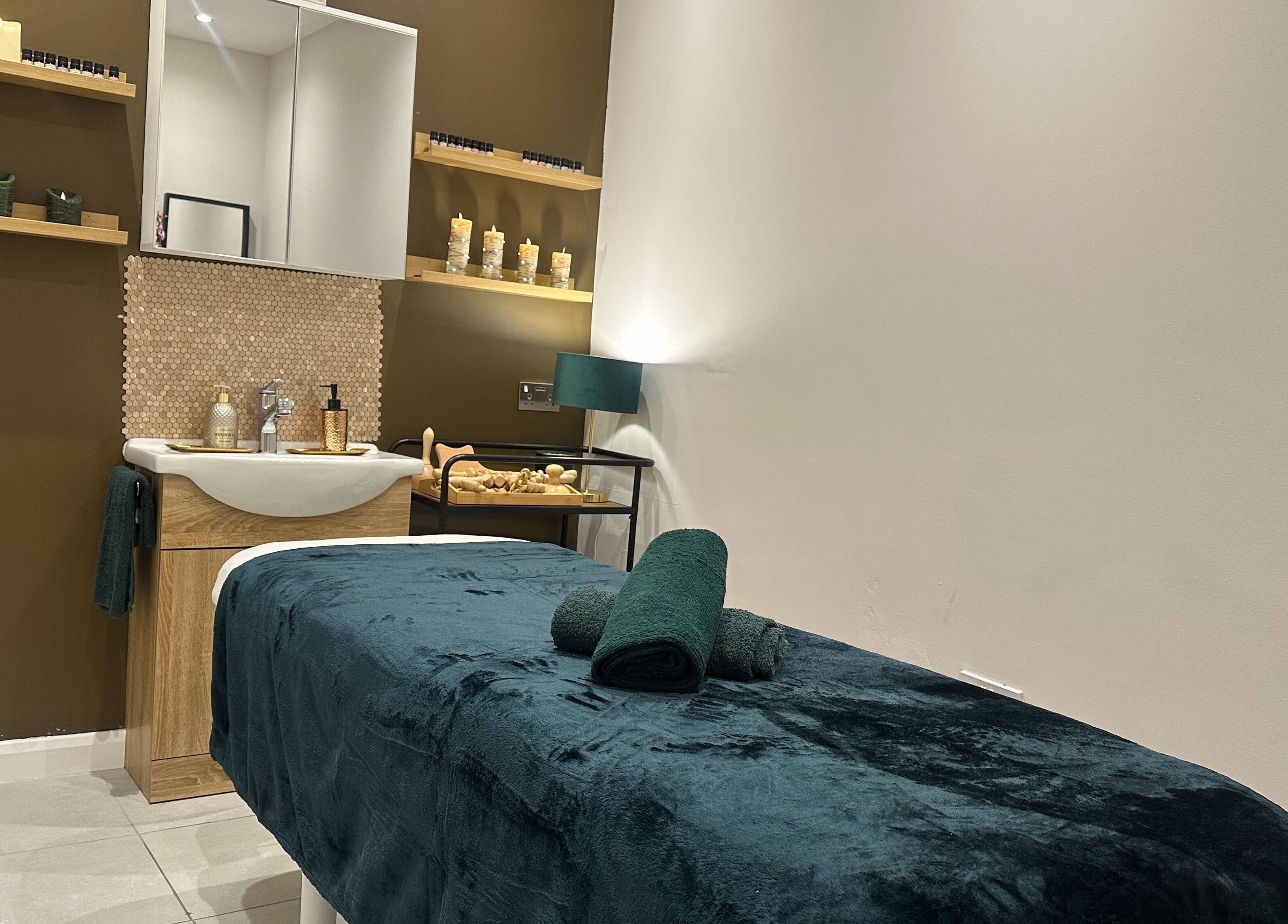 Relaxing spa room at Elite Emerald Spa, London, England, GB with plush massage table and calming decor.