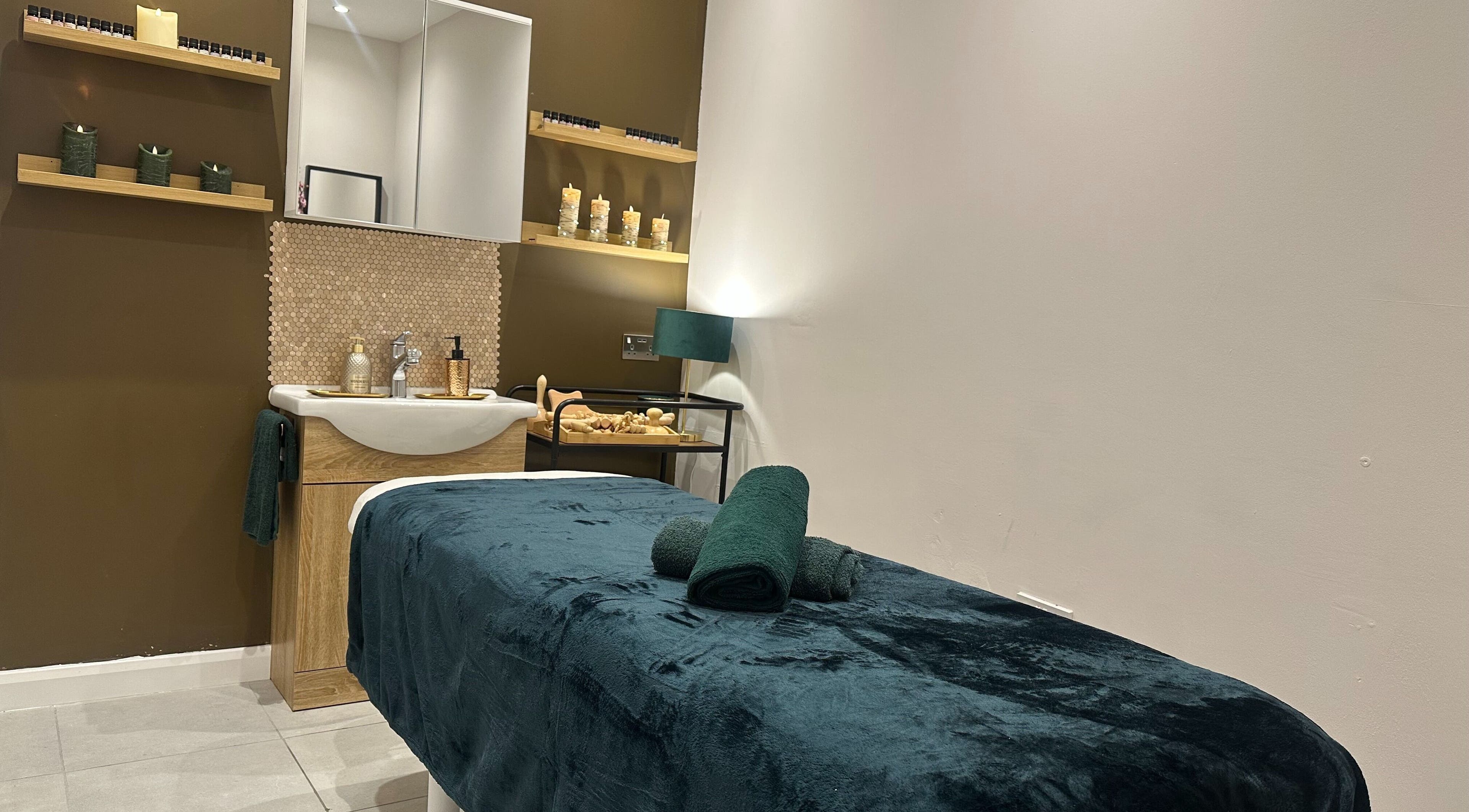 Relaxing spa room at Elite Emerald Spa, London, England, GB with plush massage table and calming decor.