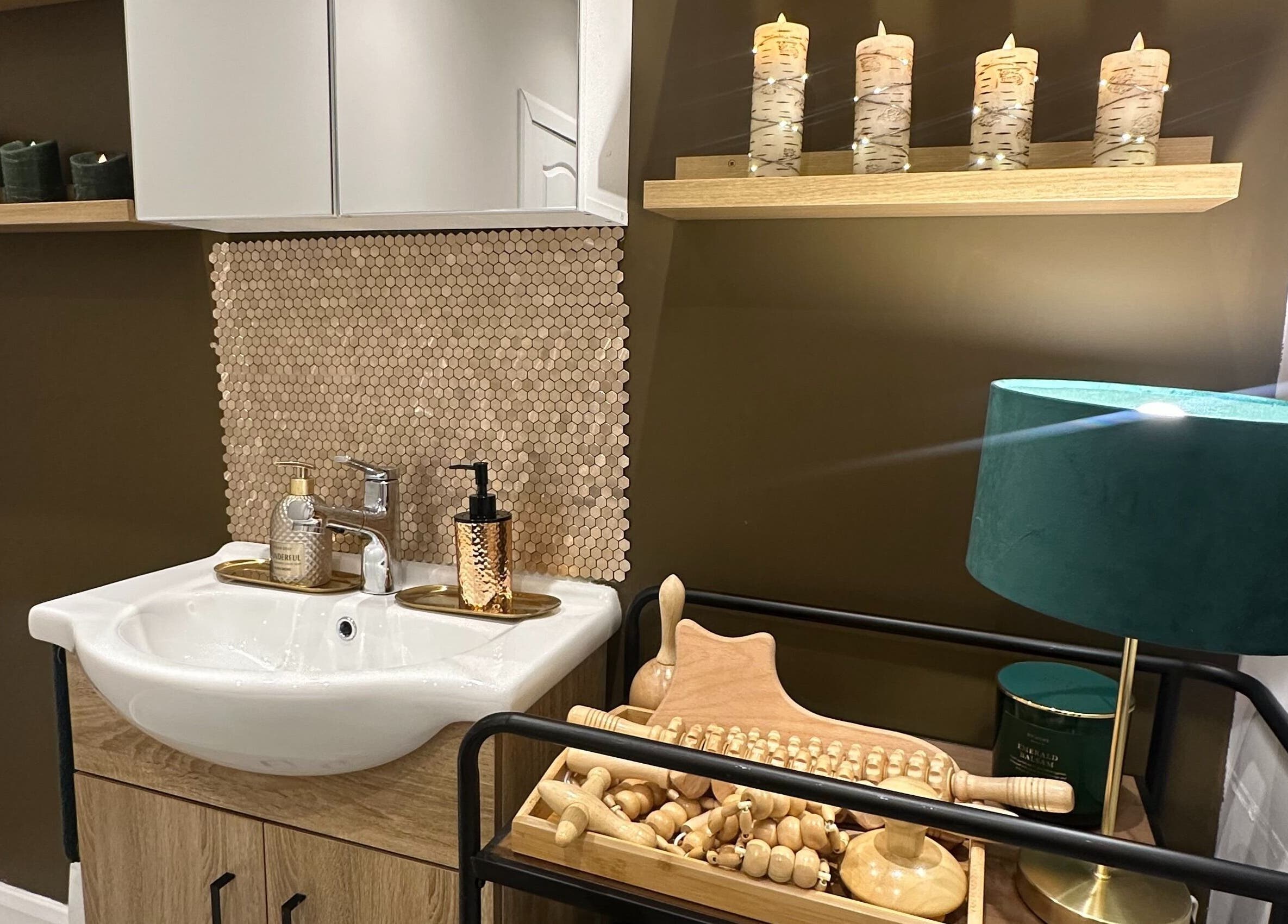 Elegant sink setup with candles at Elite Emerald Spa in London, England, GB. Enhancing relaxation ambiance.