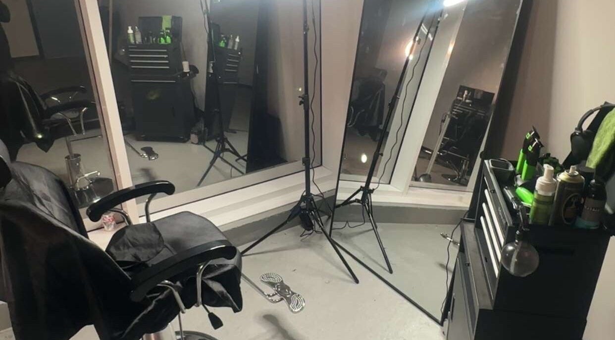 Modern beauty studio interior at Studio FX, London, England, GB, featuring styling chairs and a wall mirror.
