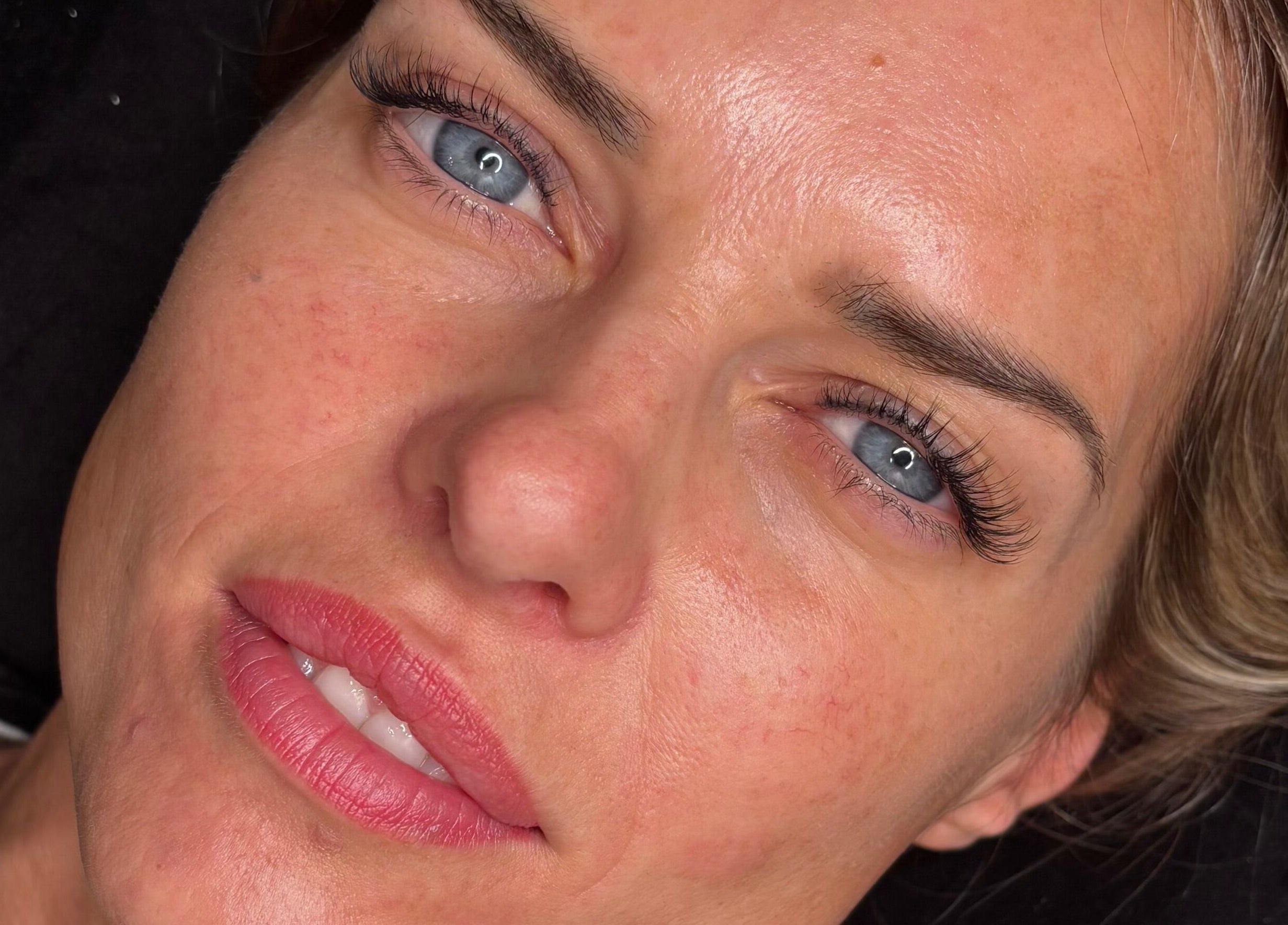 Close-up of a woman's face highlighting radiant skin and eyelashes at Beautyblissbymia_ in London, England, GB.