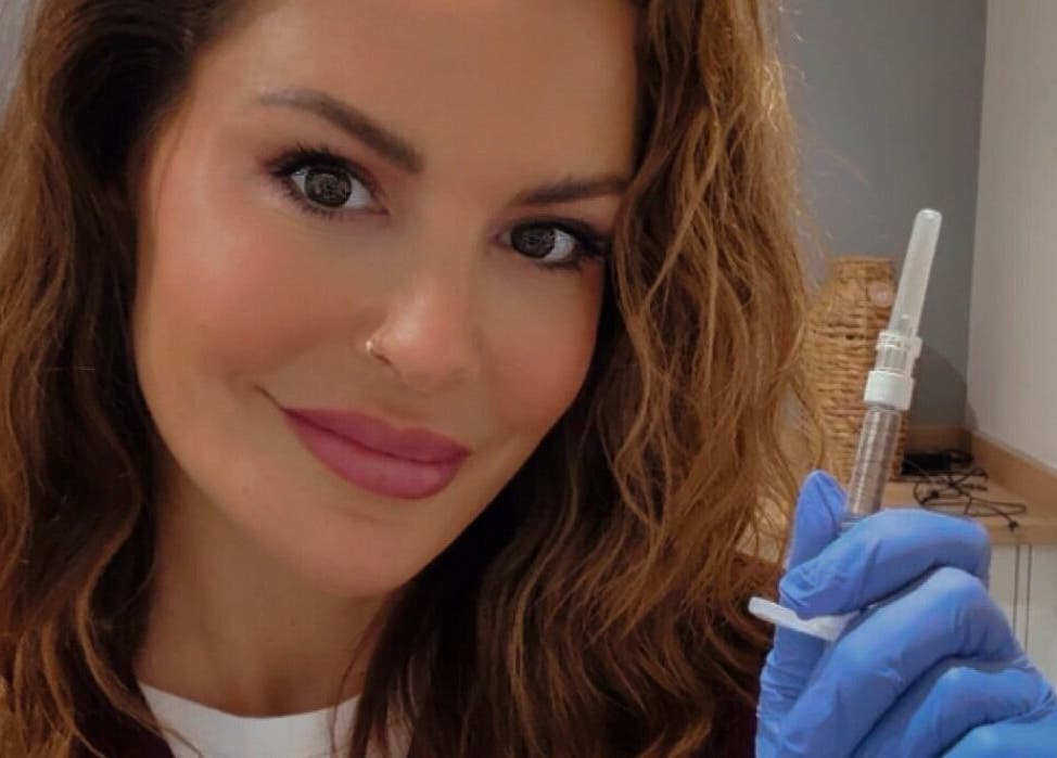 Professional at JDL Aesthetics Whitley Bay, England, GB, holding a syringe in a treatment room.