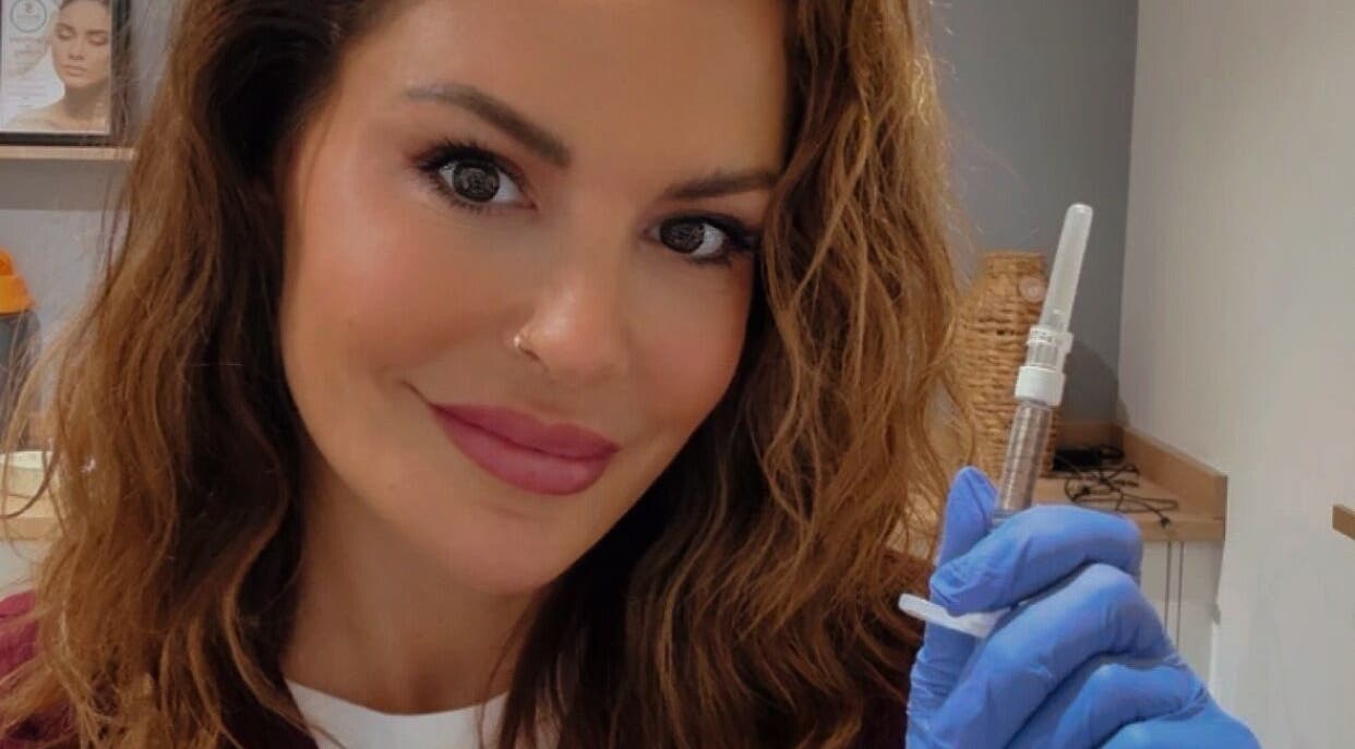 Professional at JDL Aesthetics Whitley Bay, England, GB, holding a syringe in a treatment room.