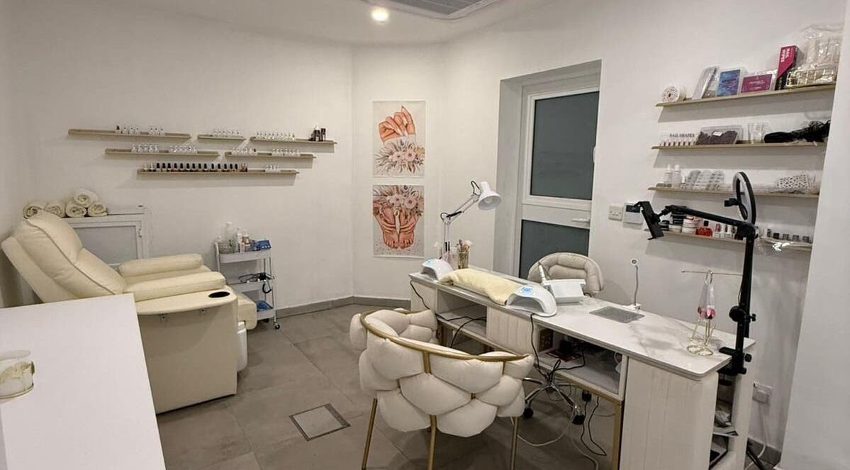 Elegant manicure station at Cosmopolitan Beauty Centre, Tas-sliema, MT, featuring modern decor and comfy seating.