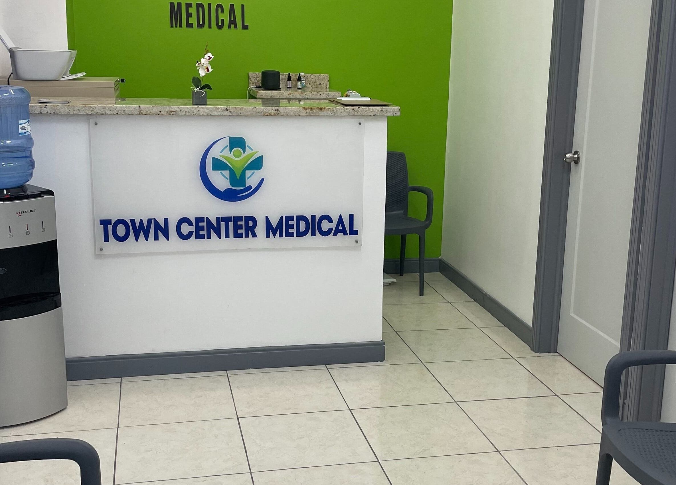 Reception area at Town Center Medical, Saint Ann's Bay, St. Ann Parish, JM with chairs and water cooler.