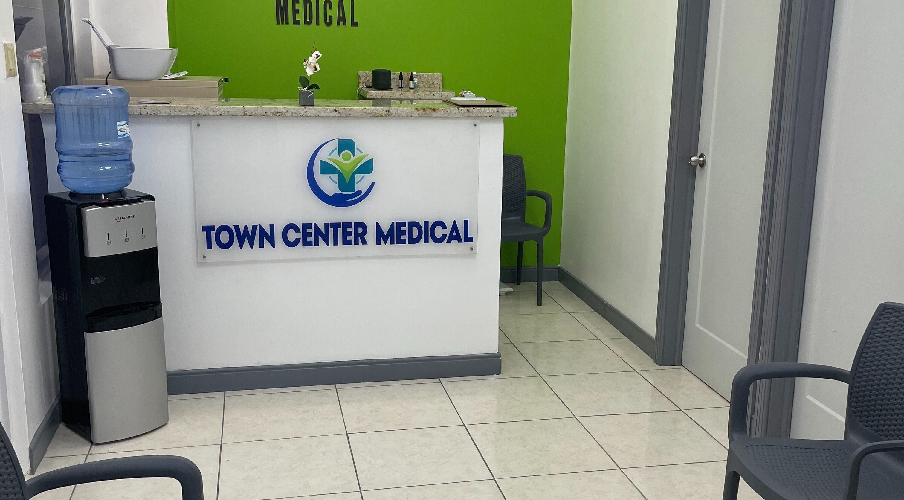 Reception area at Town Center Medical, Saint Ann's Bay, St. Ann Parish, JM with chairs and water cooler.