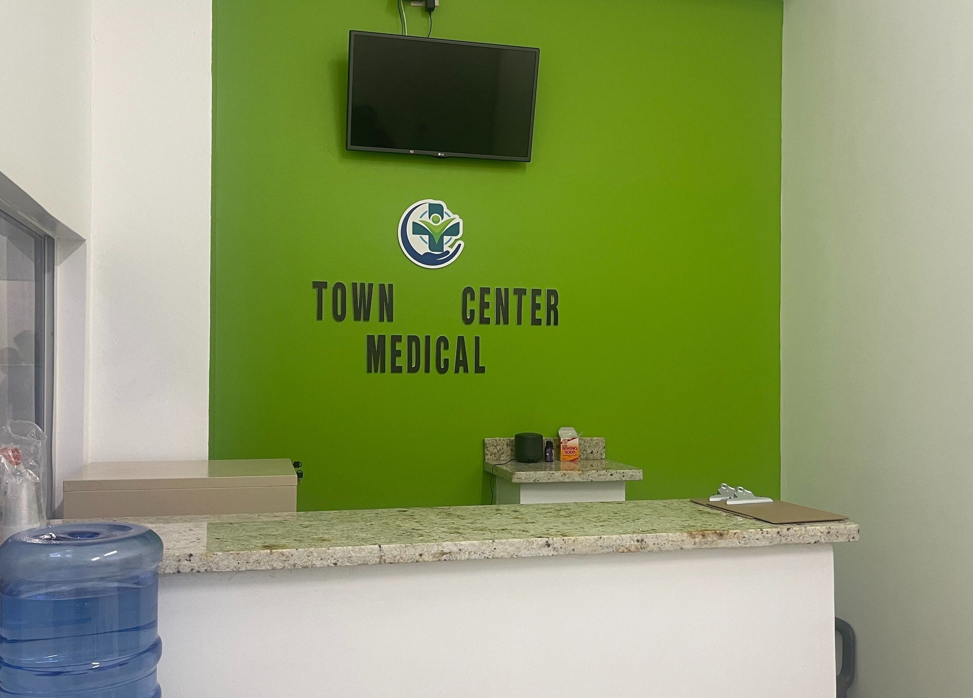 Reception desk at Town Center Medical, Saint Ann's Bay, St. Ann Parish, JM with green accent wall.