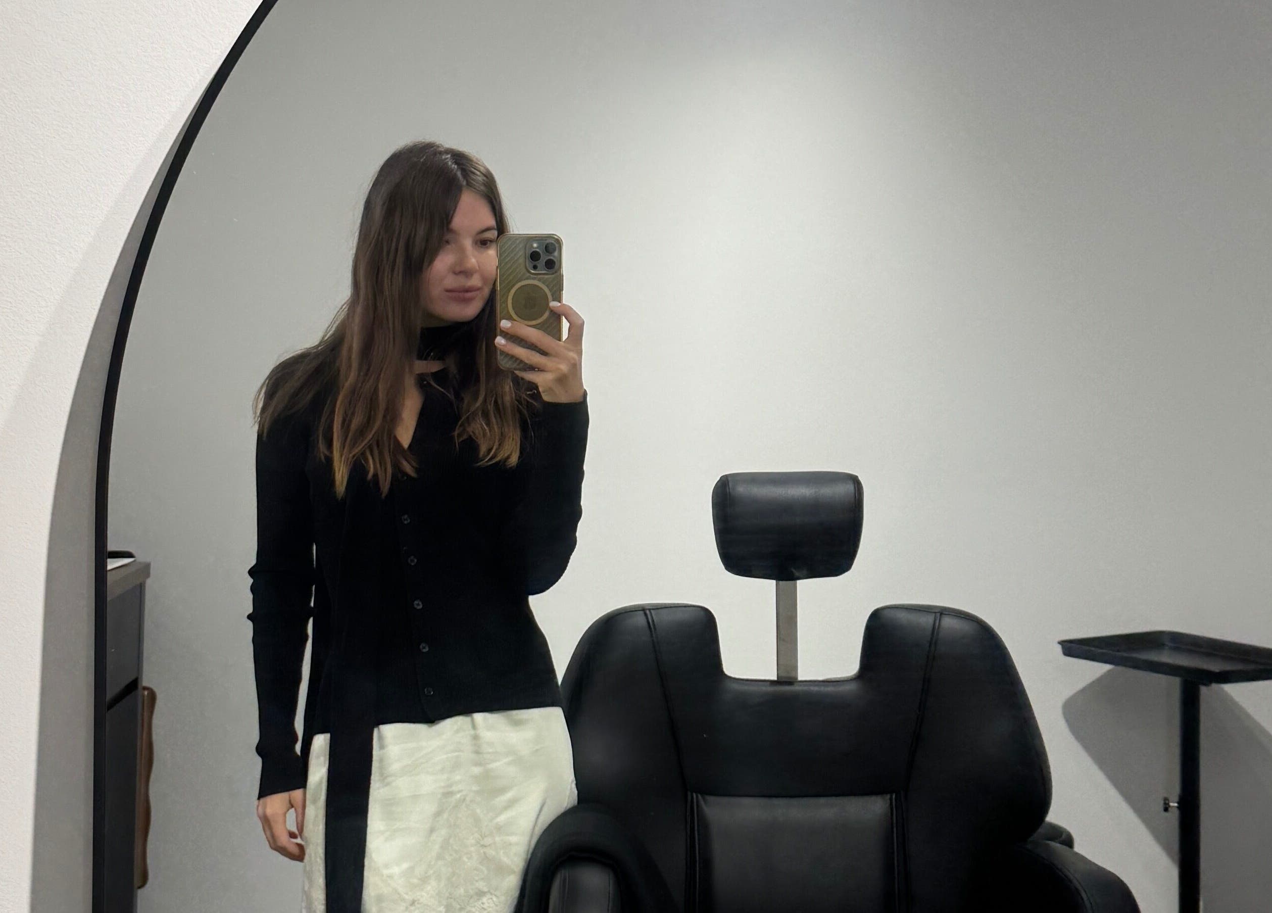 Stylish interior at Beauté Era in Glendale, California, US with a black salon chair and mirror reflection.
